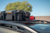 Black toolbox on Crossmembers on the 2019-2024 Subaru Forester with a clear sky and tree in the background
