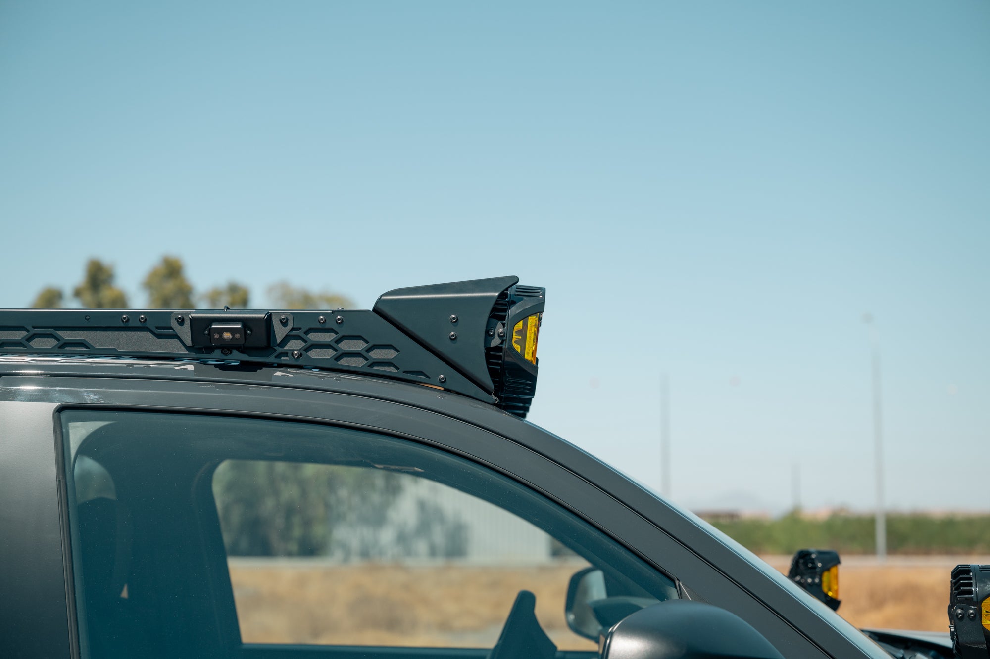 Side profile of the Roof Rack Round Light Mount installed to a Rago 4Runner Roof Rack.