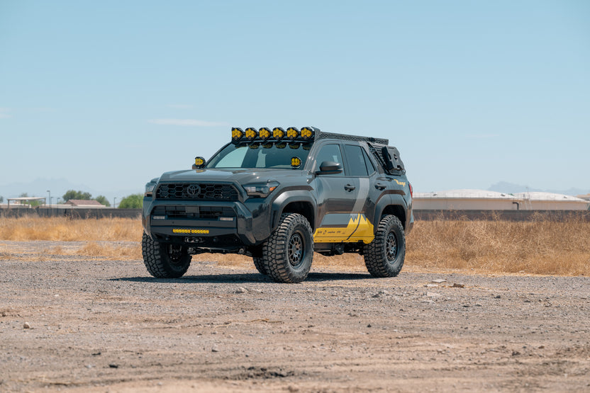 A 6th Gen 4Runner venturing off-road with a Rago Front Bumper, Roof Rack, LP6 Round Light Mount, Ditch Light Brackets, and External Rear Window Molle Panels.