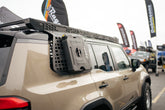 GX 550 with Exterior molle panel and roof rack at car show.