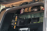 Flashlight mounted to the rear molle panels using quick fists.