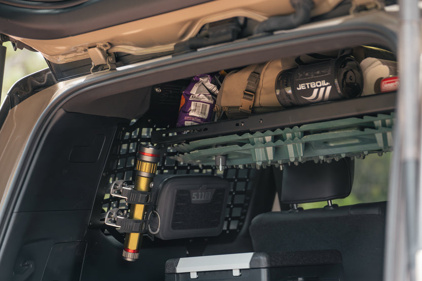 Flashlight mounted to the rear molle panels using quick fists.