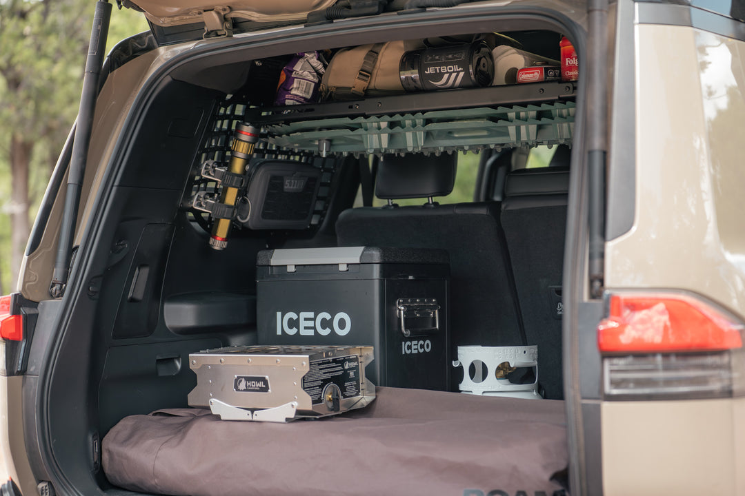 Tools and food mounted to the molle panel windows and shelf to make room for heavier camping cooler and stove in the cargo area.