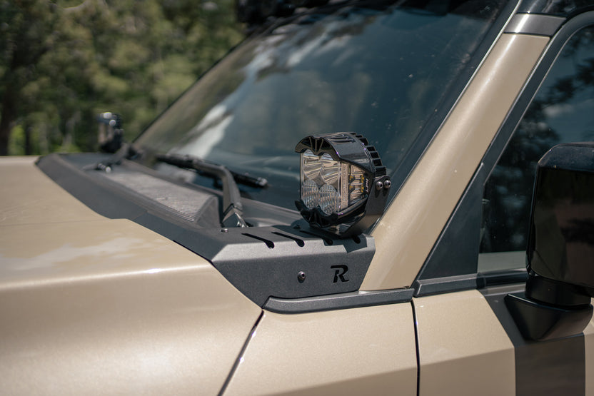 Side view of a GX 550 with a mounted light brackets and 'R' Rago logo.