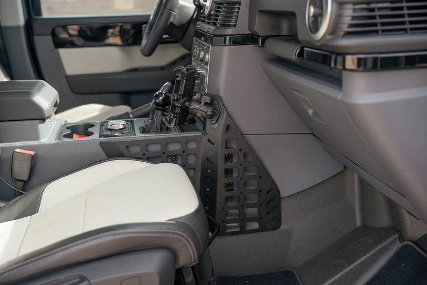 Passenger footwell view of the Center Console Molle Panels for the 2022-2026 INEOS Grenadier & Quartermaster