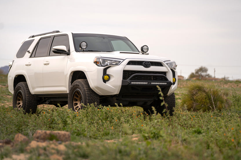 5th Gen Toyota 4Runner Ditch Light Brackets, installed on 4 runner parked in grassy field