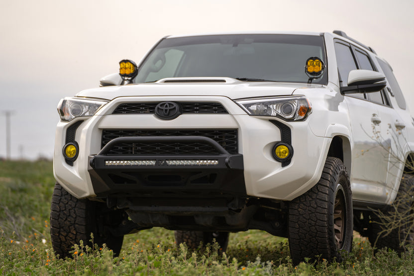 5th Gen Toyota 4Runner Ditch Light Brackets, installed on 4 runner parked in grassy field